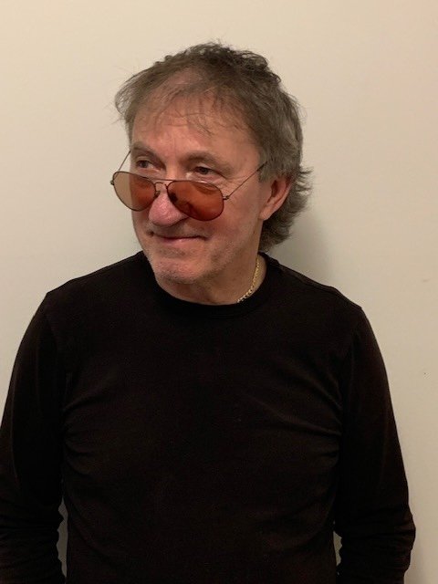 Josef Zetocha standing with his original artwork